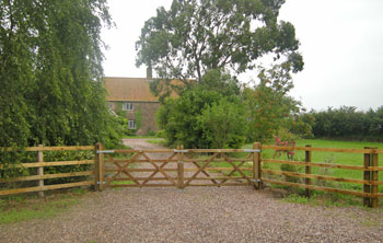 driveway with double wooden 5 bar gates
