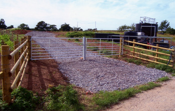 two 10 foot metal field gates with central latching post
